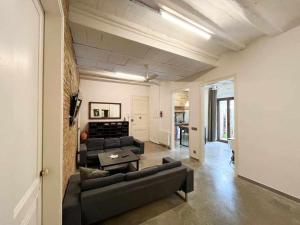 a living room with a couch and a table at Aptw Pool in heart of old town in Girona