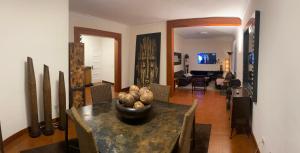 a dining room with a table and a living room at OFF Ciudad Jardin in Las Palmas de Gran Canaria