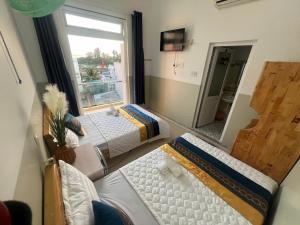 a large room with two beds and a window at Khách Sạn Thu Thành in Ly Son