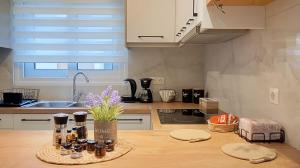 a kitchen with a wooden counter top with bottles on it at Venetton Garden House Corfu in Gouvia