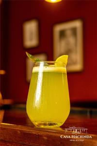 a yellow drink sitting on top of a table at Casa Hacienda Hotel Boutique in Cajamarca
