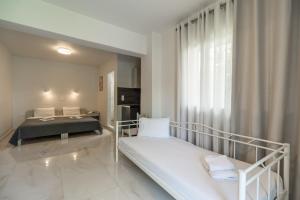 Posteľ alebo postele v izbe v ubytovaní Rhoe Seaside Apartments