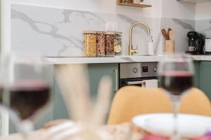 a person sitting at a table with a glass of wine at Lavande Dorée in Avignon +33 photos