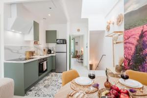 a kitchen and dining room with a table and chairs at Lavande Dorée in Avignon