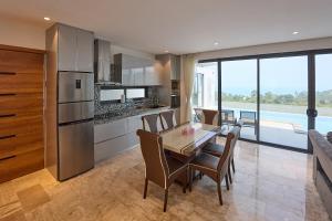 a kitchen and dining room with a table and chairs at Sea view Villa Josefina - 3 bedroom in Nathon Bay