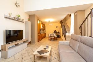 a living room with a couch and a tv at Grandma's House in Sorrento