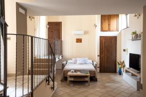 a living room with a bed and a tv at Grandma's House in Sorrento