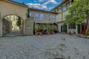 an empty courtyard in front of a building with potted plants at Barchi Resort - Apartments & Suites in San Felice del Benaco +47 photos