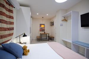 a bedroom with a bed with a teddy bear sitting on it at Osito Hub - l'Explorador Andrés in Valencia