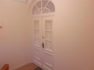 une porte blanche avec une fenêtre dans une pièce dans l'établissement Ferienwohnung Alte Post Retzen, à Bad Salzuflen