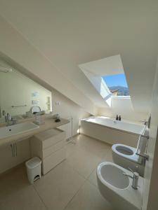 a white bathroom with a sink and a toilet at Blue horizon retreat-Luxury Penthouse in Rapallo +32 photos