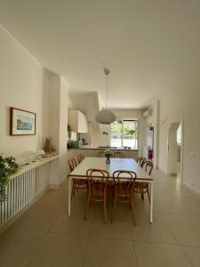 a kitchen and dining room with a table and chairs at Blue horizon retreat-Luxury Penthouse in Rapallo