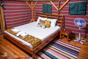 a bed in a room on a boat at Murchison Palace in Pakwach East