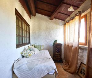 a bedroom with a bed in a room with a window at Maison Florence in Valliguières