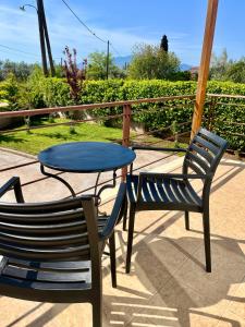 a table and two chairs sitting next to a table at Ellegant apartment in Politika in Politika