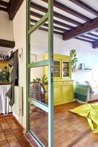 a room with a glass door in a room at Maison Florence in Valliguières