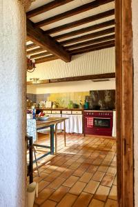 a kitchen with a table in the middle of it at Maison Florence in Valliguières