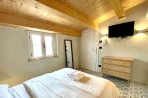 a bedroom with a bed and a tv on the wall at Affittacamere Casa Florens Guest House in San Benedetto del Tronto