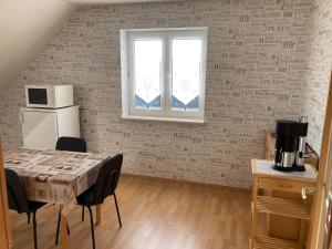 a room with a table and chairs and a window at FEWO scudici in Schkeuditz