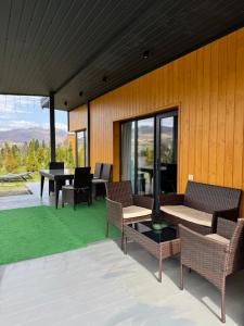 a patio with chairs and tables and a table with a view at Grey apartments in Slavske