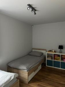 a bedroom with a bed and a ceiling fan at Domek na Morenowym Wzgórzu, nad jeziorem in Mierzyn