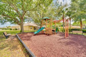 a playground with a slide and a bench at Pool Access Family-Friendly Poinciana Condo! in Poinciana