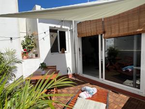 a porch of a house with a sliding glass door at Sunny Cozy & Pretty Penthouse in Central SC in Santa Cruz de Tenerife