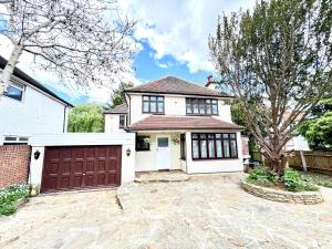 a white house with a brown garage at 304 Norbury House in Norbury