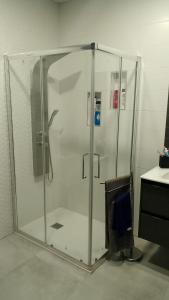 a shower with a glass enclosure in a bathroom at Casa Marcé in Córdoba