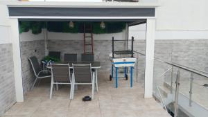 a patio with a table and chairs on a building at Casa Marcé in Córdoba