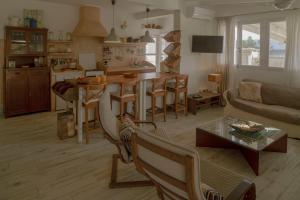 a kitchen and living room with a table and a couch at Casa Armonia in Illes Balears