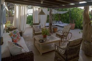 a patio with chairs and a table and a couch at Casa Armonia in Illes Balears