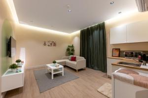 a living room with a couch and a kitchen at بيتك - Baytak in Al Madinah