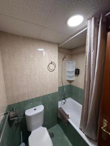 a bathroom with a toilet and a bath tub at Ole Jerez! in Jerez de la Frontera