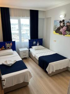 Ein Bett oder Betten in einem Zimmer der Unterkunft Marla Didim Otel