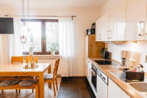 a kitchen with a table and a dining room at Huxfeld-Hof - Landlust in Grasberg