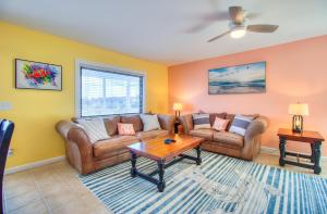 a living room with two couches and a table at Sea La Vie by Carolina Beach Realty in Carolina Beach