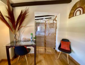 a dining room with a table and two chairs at Bungalow Aloha, Piscina Privada, Playa y Barbacoa in Benalmádena