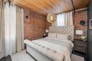 a bedroom with a brick wall and a large bed at Westside Escape in Cookeville
