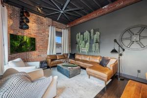 a living room with leather furniture and a brick wall at Westside Escape in Cookeville