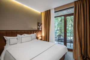 Postel nebo postele na pokoji v ubytování Elea Old Tbilisi Hotel