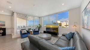 a living room with a couch and a large window at Ten35 Seaside Rentals in Siesta Key