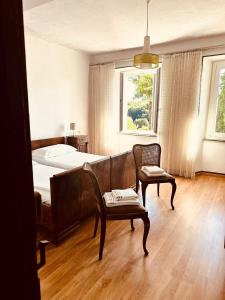 a bedroom with a bed and a couch and a chair at Albergo della Posta in Astano