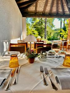 a table with utensils on a white table cloth at Albergo della Posta in Astano