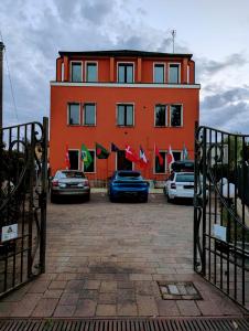 a large orange building with cars parked in front of it at Venice Luxury Apartment in Venice
