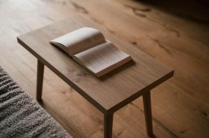 a book sitting on a wooden coffee table at Boutique Hotel Pachers in Bressanone