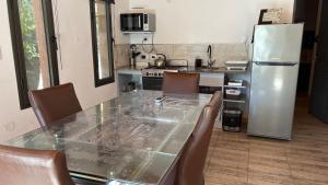 a kitchen with a table and chairs and a refrigerator at Luz del Rincón in Merlo