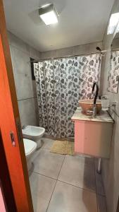 a bathroom with a sink and a toilet and a shower at Luz del Rincón in Merlo
