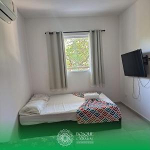 a small bed in a room with a window at Refúgio Vista Bosque x Piscina in Camaragibe +30 photos