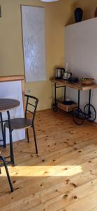 a room with tables and chairs and a wooden floor at Apartments Elena & Damir in Vis